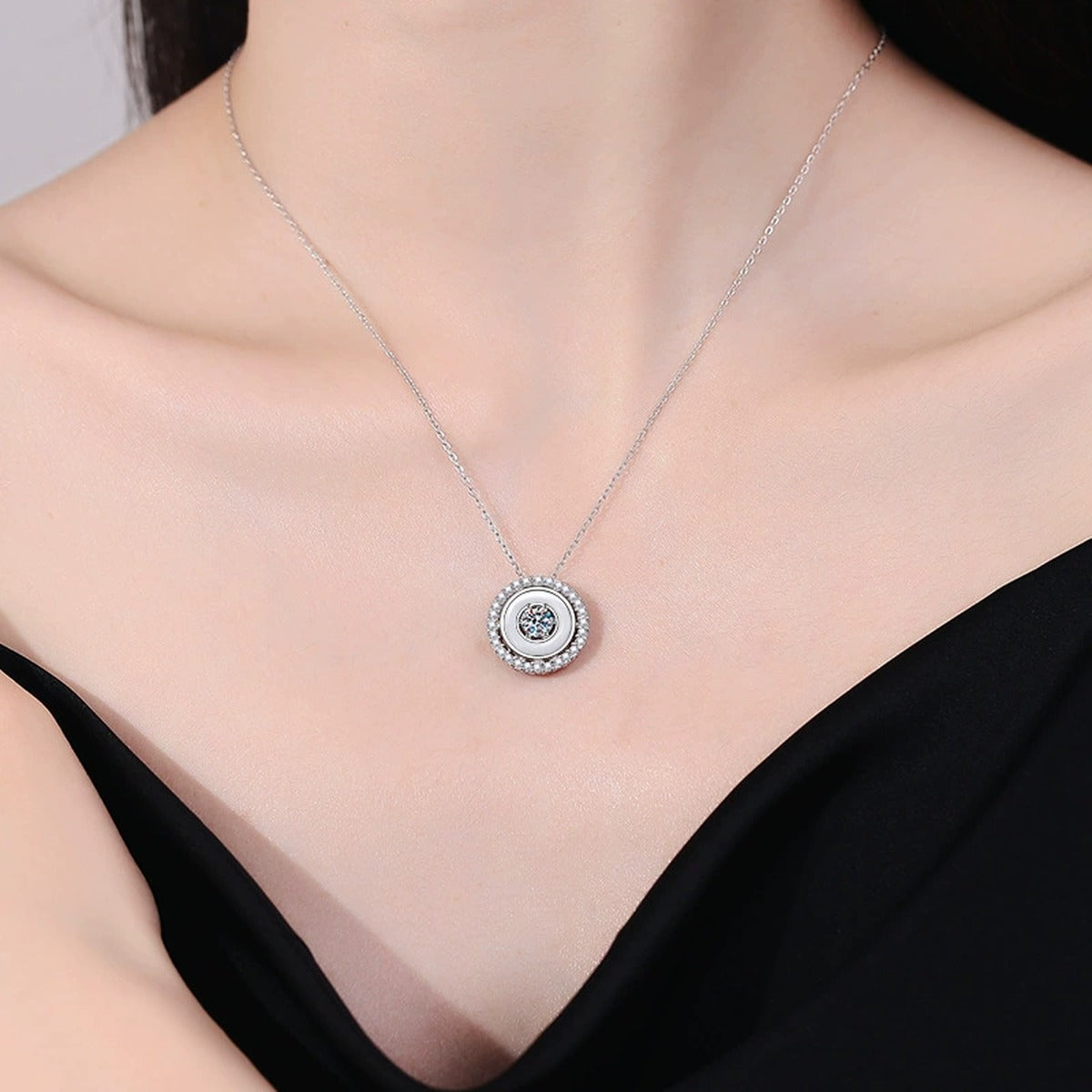 Round Bezel Halo Moissanite Pendant Necklace in Platinum-Plated S925 Sterling Silver worn on neckline by model