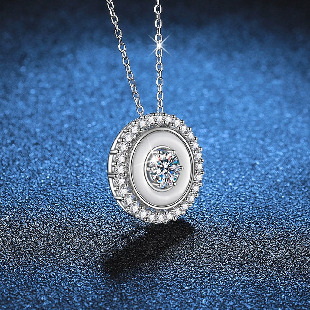 Round Bezel Halo Moissanite Pendant Necklace in Platinum-Plated S925 Sterling Silver blue background angled view