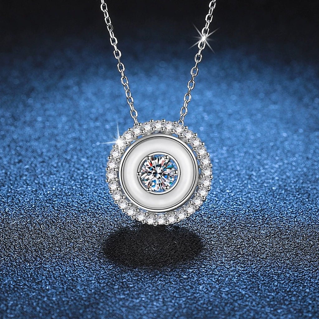 Round Bezel Halo Moissanite Pendant Necklace in Platinum-Plated S925 Sterling Silver blue background close-up view