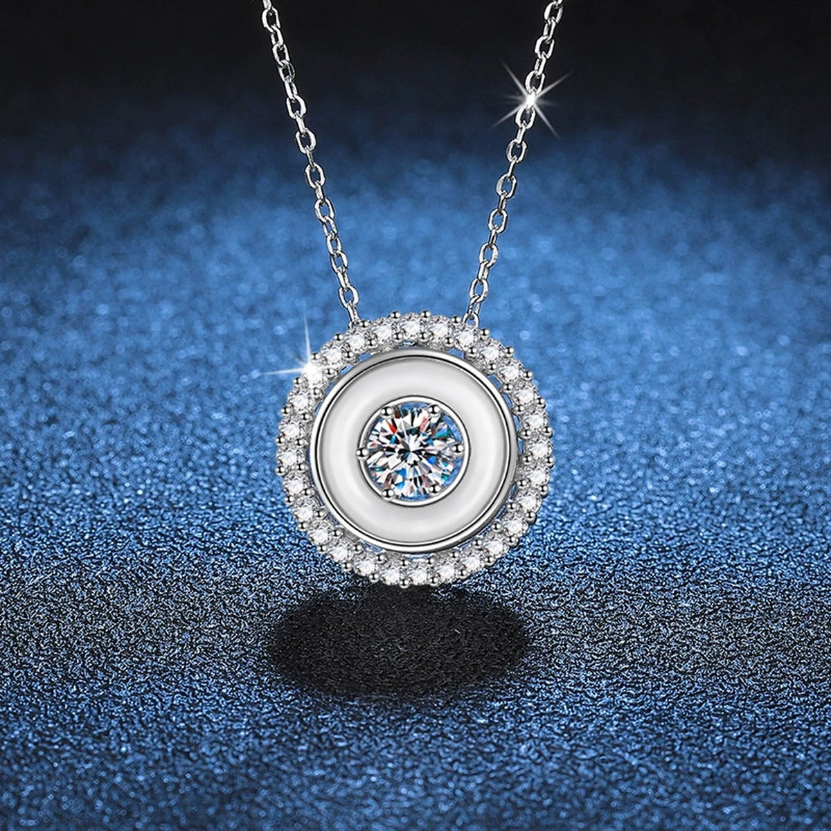 Round Bezel Halo Moissanite Pendant Necklace in Platinum-Plated S925 Sterling Silver blue background close-up view