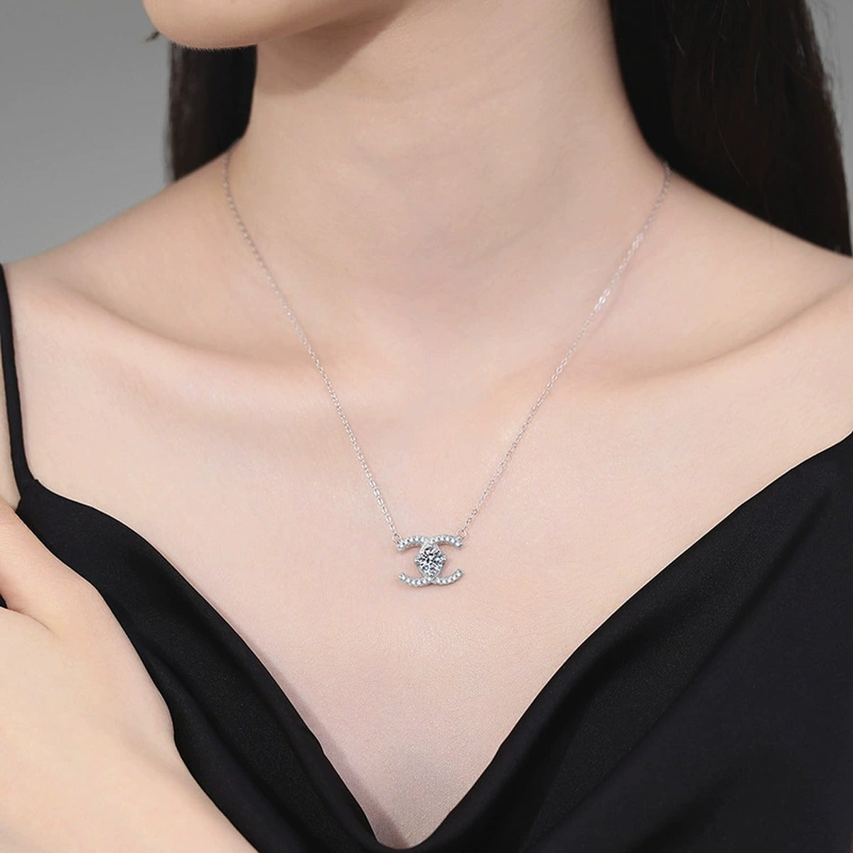 Interlocking C Moissanite Pendant Necklace in Platinum-Plated S925 Sterling Silver worn on neckline by model