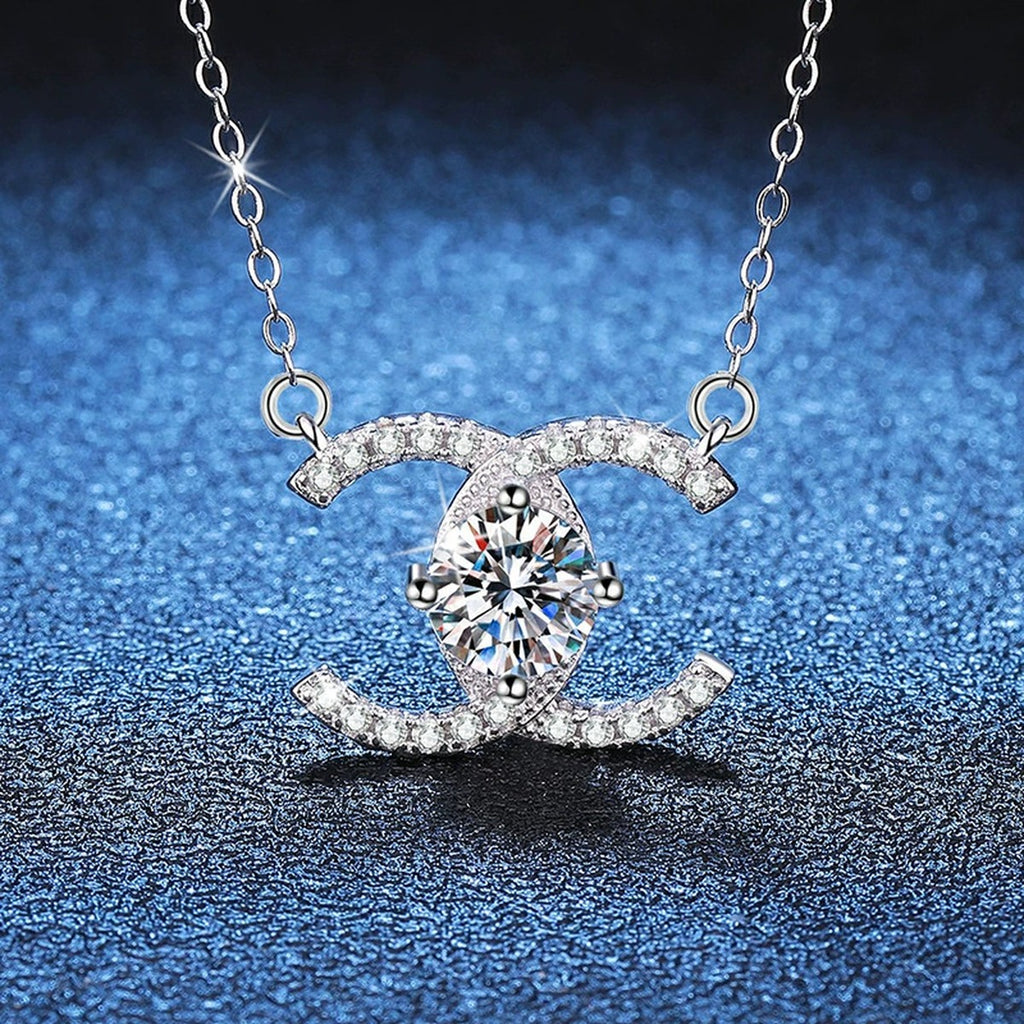 Interlocking C Moissanite Pendant Necklace in Platinum-Plated S925 Sterling Silver blue background angled view