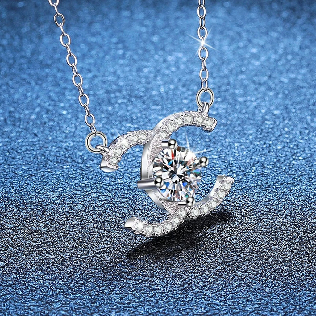 Interlocking C Moissanite Pendant Necklace in Platinum-Plated S925 Sterling Silver blue background close-up view