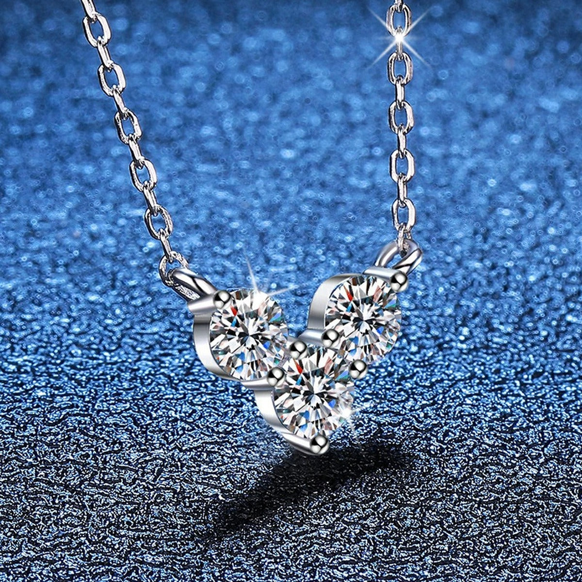 Three-Stone Moissanite Station Necklace in Platinum-Plated S925 Sterling Silver blue background angled view