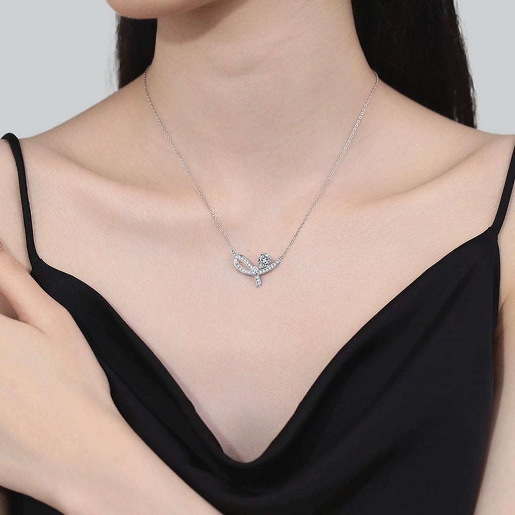 Pear-Cut Moissanite Ribbon Necklace in Platinum-Plated S925 Sterling Silver worn on neckline by model