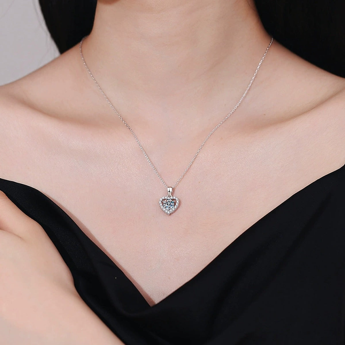 Heart Halo Moissanite Jewelry Style in Platinum-Plated S925 Sterling Silver worn on neckline by model