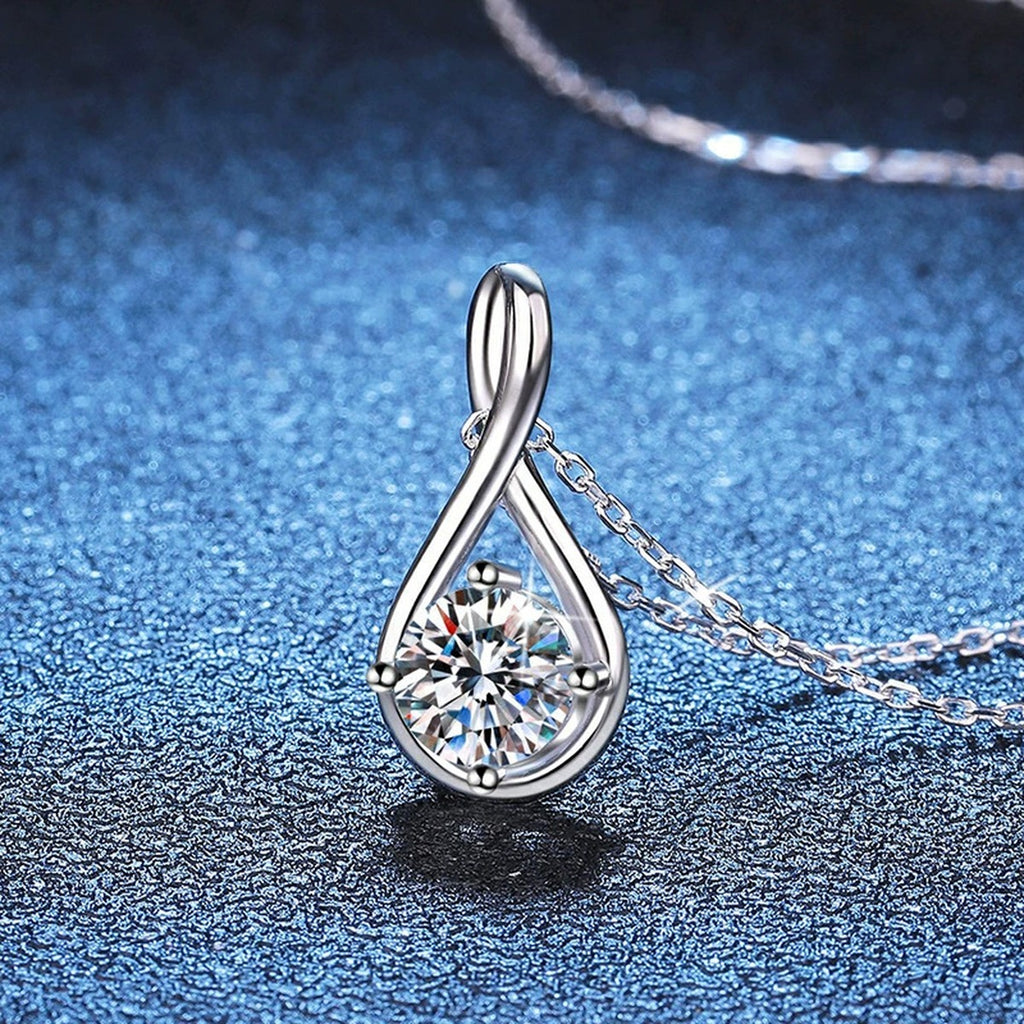 Teardrop Moissanite Pendant Necklace in Platinum-Plated S925 Sterling Silver blue background angled view