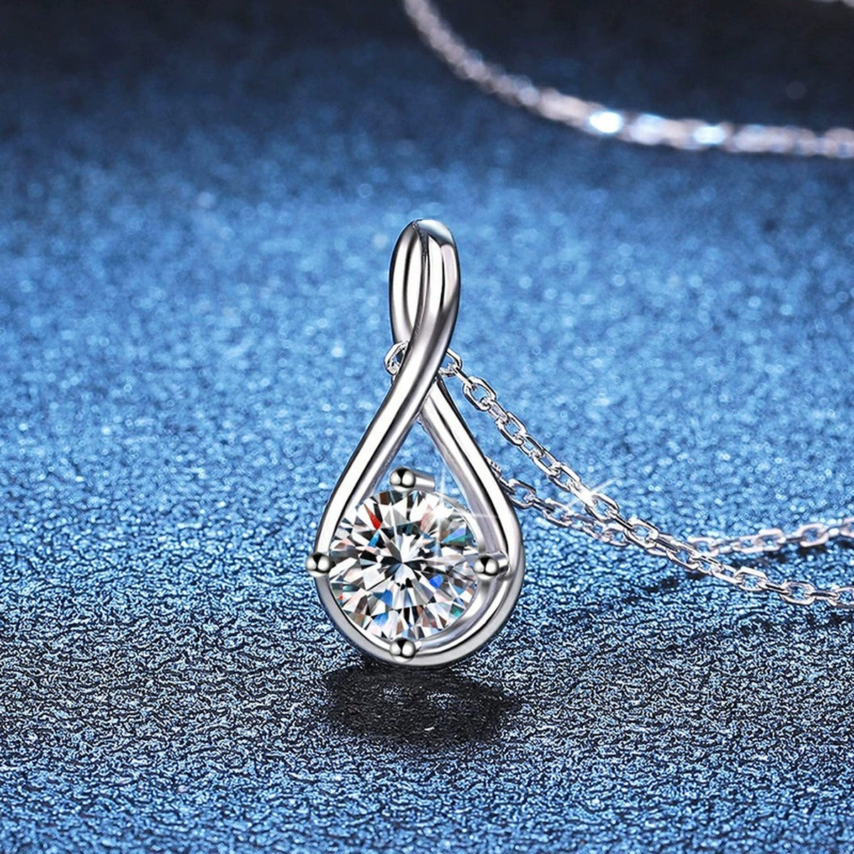 Teardrop Moissanite Pendant Necklace in Platinum-Plated S925 Sterling Silver blue background angled view