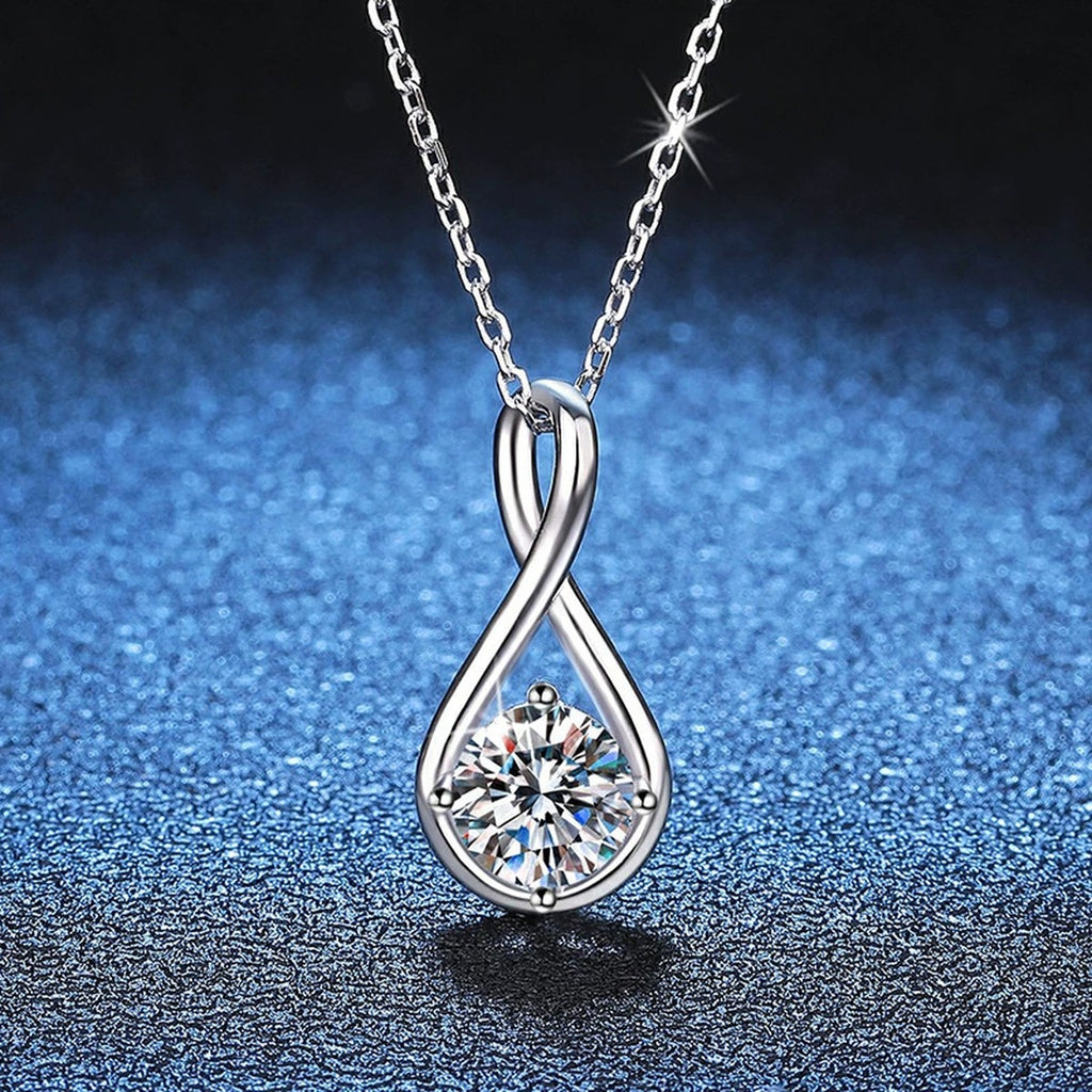 Teardrop Moissanite Pendant Necklace in Platinum-Plated S925 Sterling Silver blue background close-up view