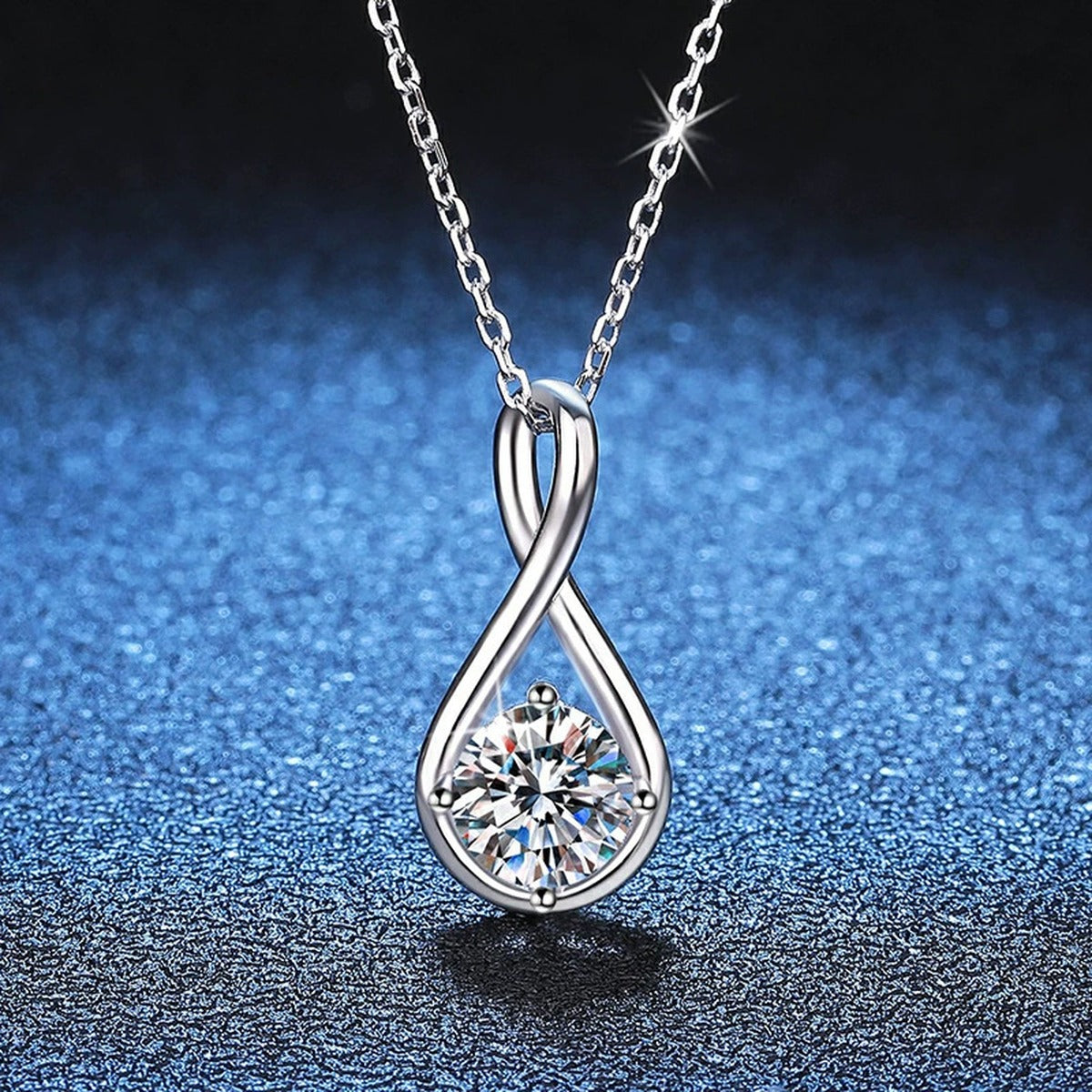 Teardrop Moissanite Pendant Necklace in Platinum-Plated S925 Sterling Silver blue background close-up view