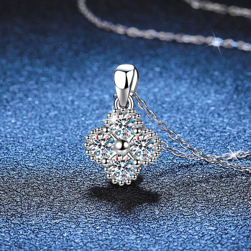 Four-Stone Cluster Moissanite Pendant Necklace in Platinum-Plated S925 Sterling Silver blue background angled view