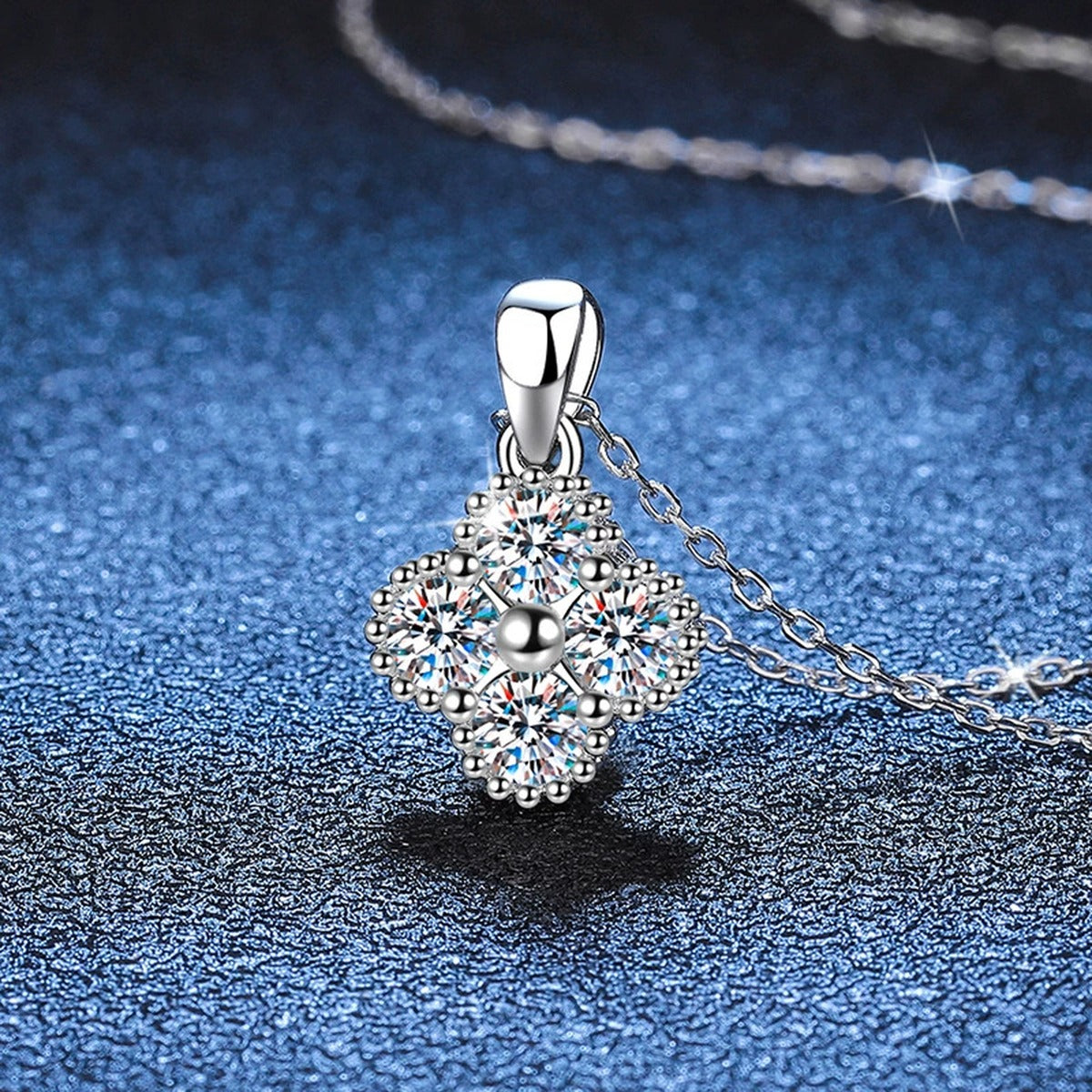 Four-Stone Cluster Moissanite Pendant Necklace in Platinum-Plated S925 Sterling Silver blue background angled view