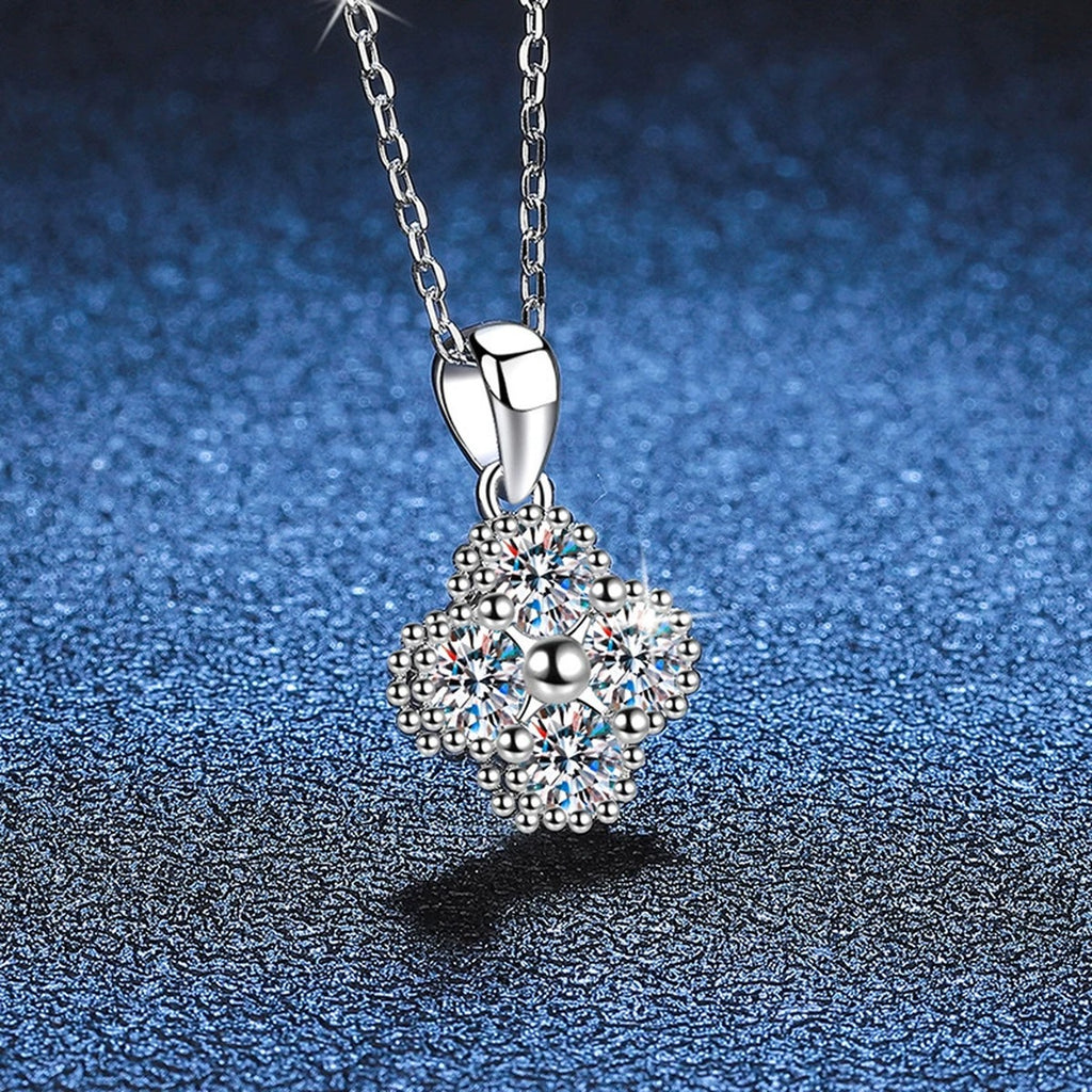 Four-Stone Cluster Moissanite Pendant Necklace in Platinum-Plated S925 Sterling Silver blue background close-up view