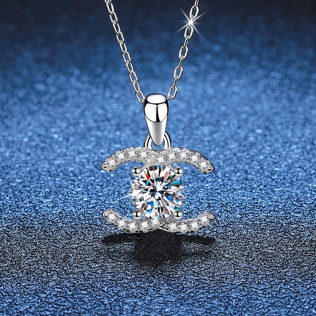 Crescent Halo Moissanite Pendant Necklace in White Gold-Plated and Yellow Gold-Plated S925 Sterling Silver blue background angled view