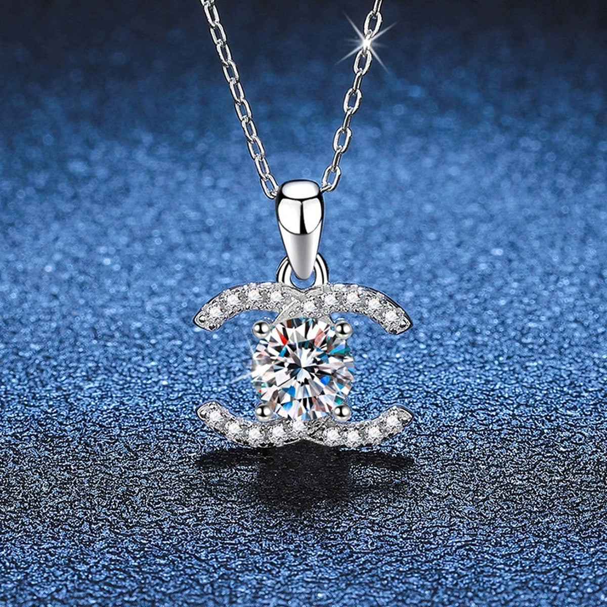 Crescent Halo Moissanite Pendant Necklace in White Gold-Plated and Yellow Gold-Plated S925 Sterling Silver blue background angled view