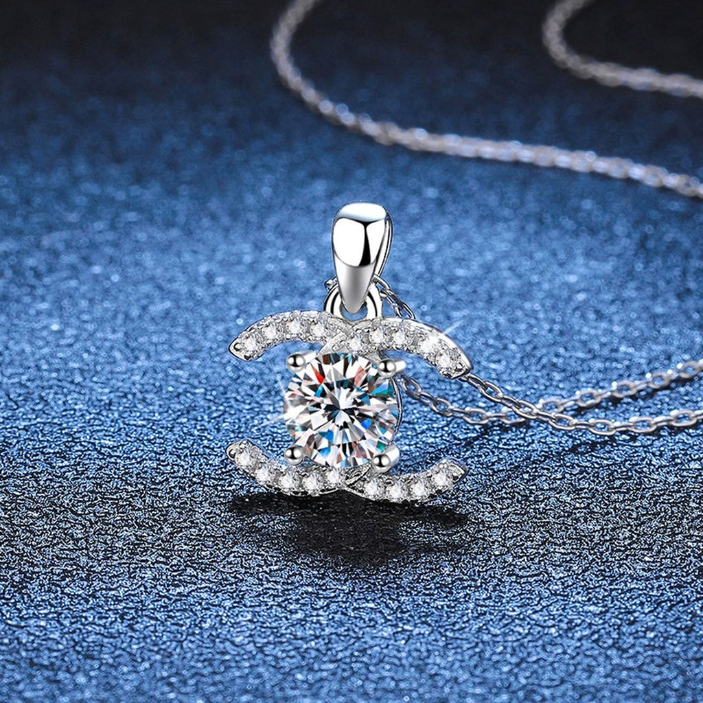 Crescent Halo Moissanite Pendant Necklace in White Gold-Plated and Yellow Gold-Plated S925 Sterling Silver blue background close-up view
