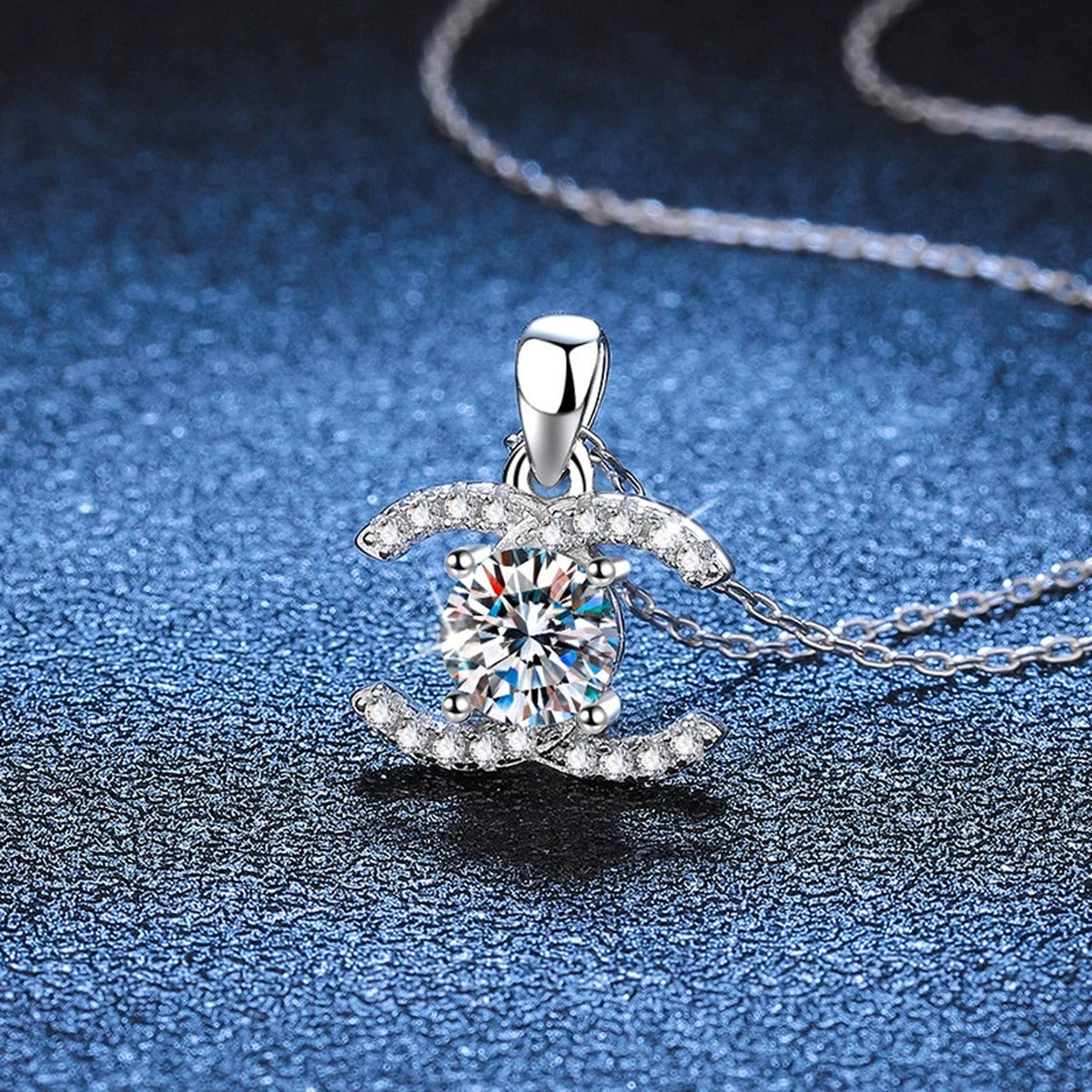 Crescent Halo Moissanite Pendant Necklace in White Gold-Plated and Yellow Gold-Plated S925 Sterling Silver blue background close-up view