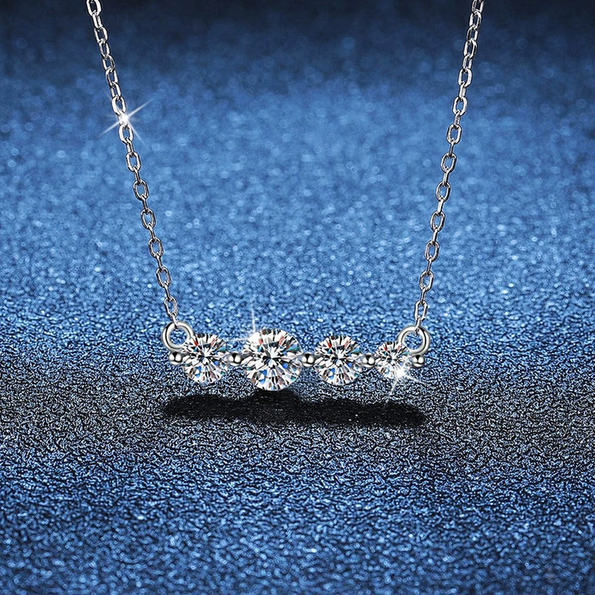 Four-Stone Moissanite Station Necklace in Platinum-Plated S925 Sterling Silver blue background angled view