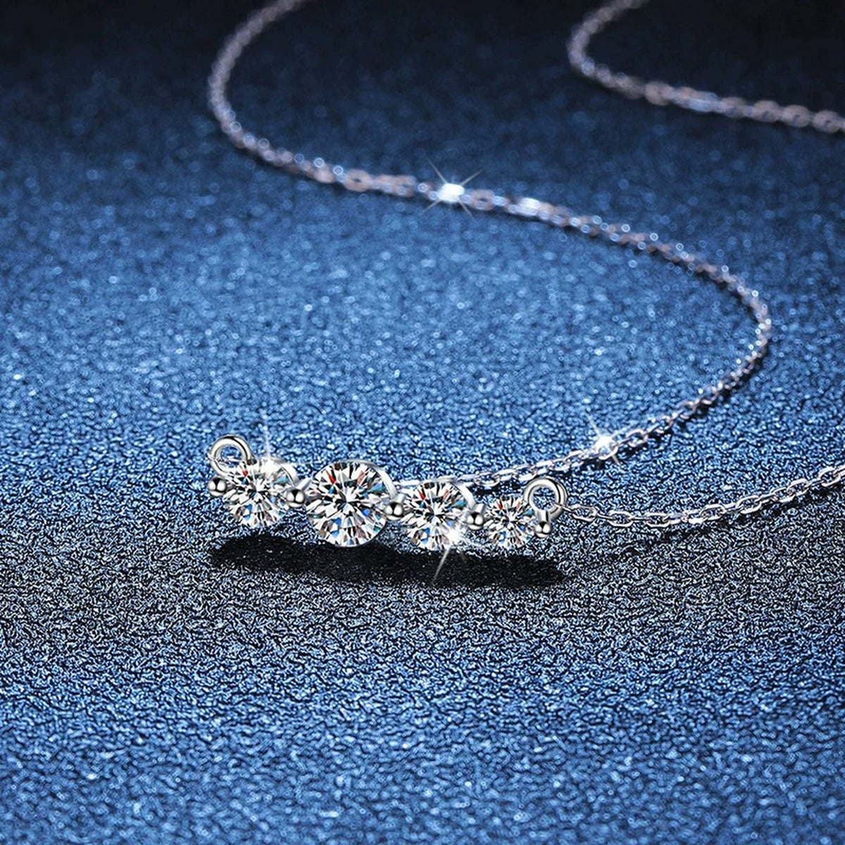 Four-Stone Moissanite Station Necklace in Platinum-Plated S925 Sterling Silver blue background close-up view