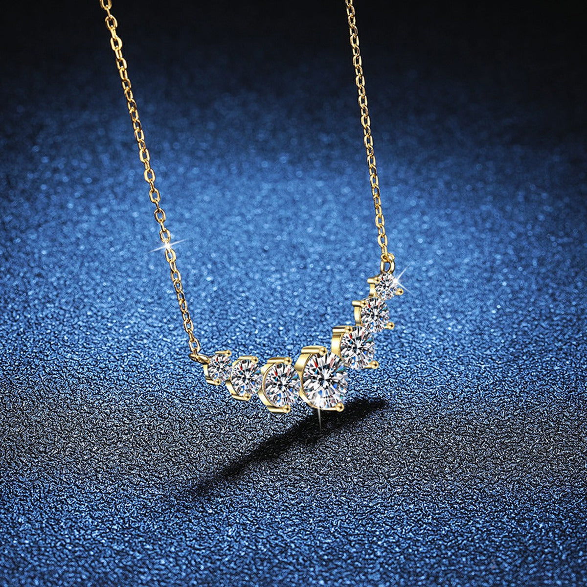 Graduated Moissanite Collar Necklace in Yellow Gold-Plated S925 Sterling Silver blue background close-up view