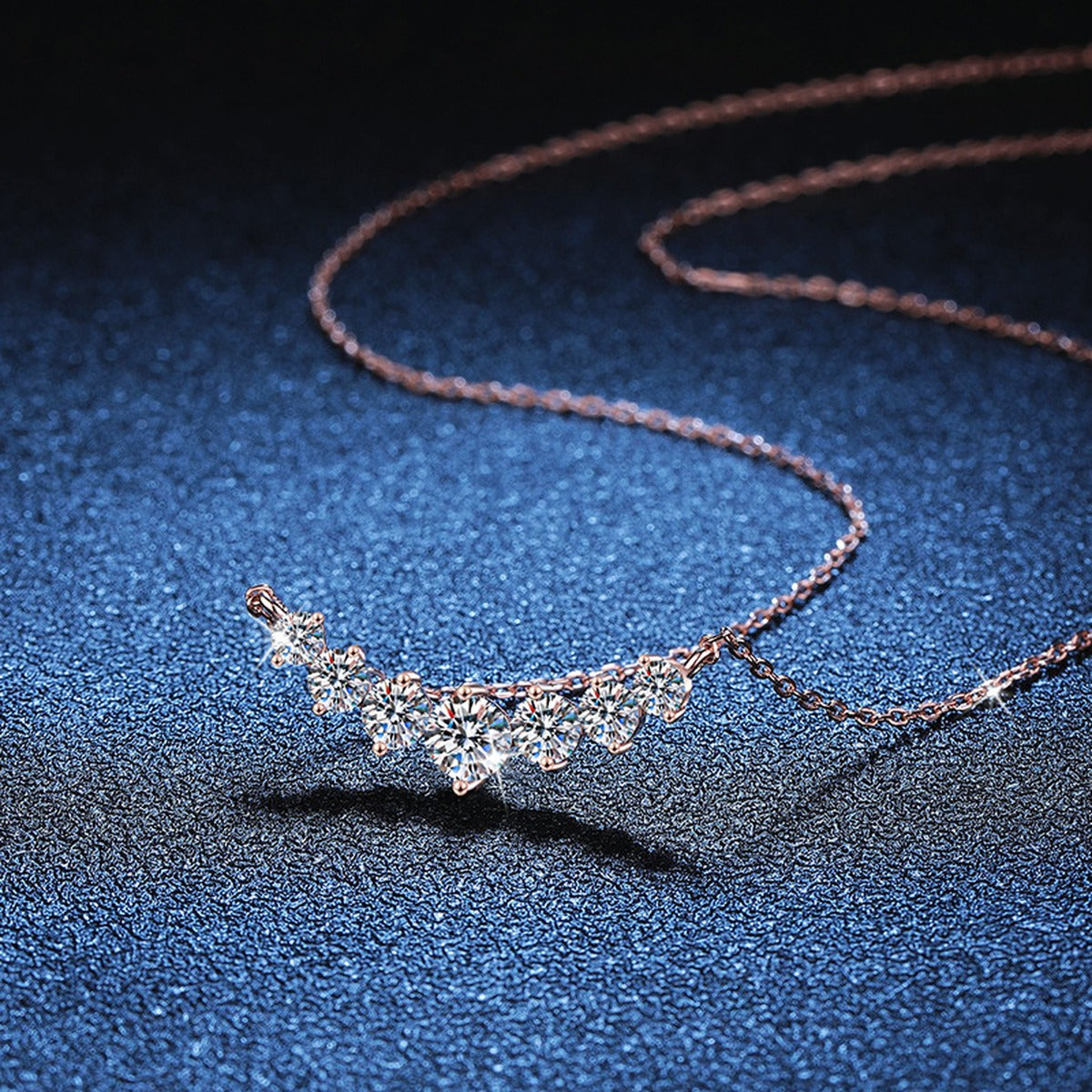 Graduated Moissanite Collar Necklace in Rose Gold-Plated S925 Sterling Silver blue background close-up view