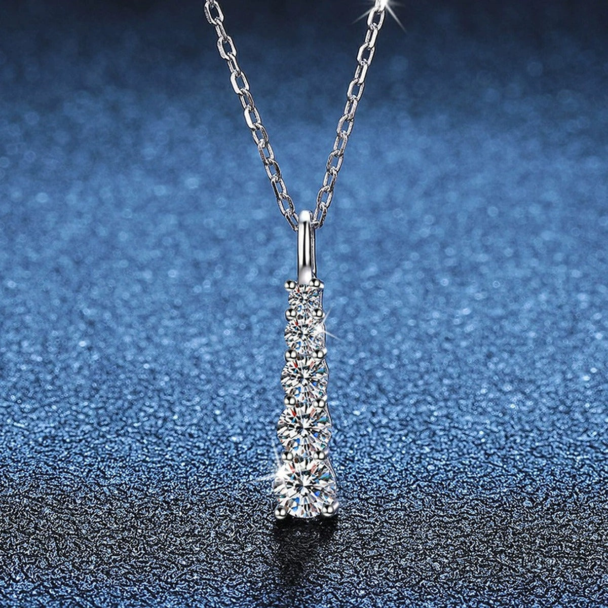 Tapered Bar Moissanite Pendant Necklace in Platinum-Plated S925 Sterling Silver blue background angled view