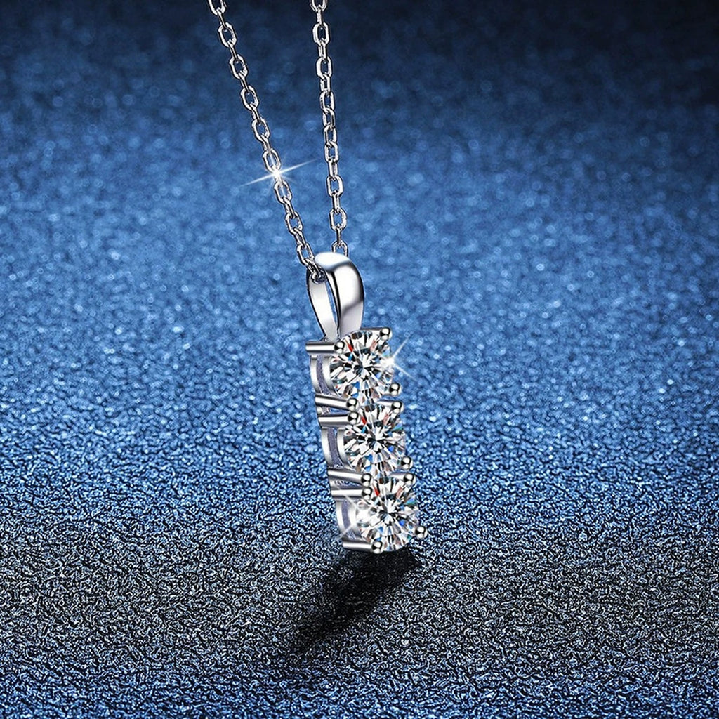Three-Stone Bar Moissanite Pendant Necklace in Platinum-Plated S925 Sterling Silver blue background close-up view