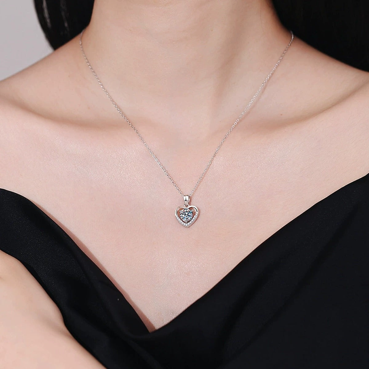 Heart Halo Moissanite Pendant Necklace in Platinum-Plated S925 Sterling Silver worn on neckline by model