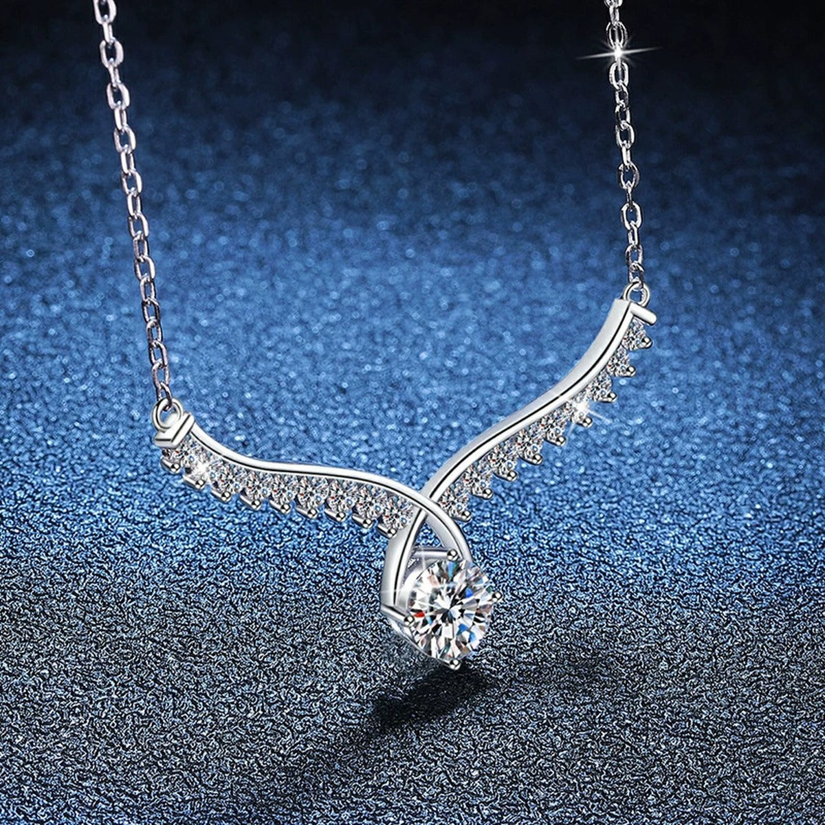 Pear Drop Moissanite Collar Necklace in Platinum-Plated S925 Sterling Silver blue background angled view