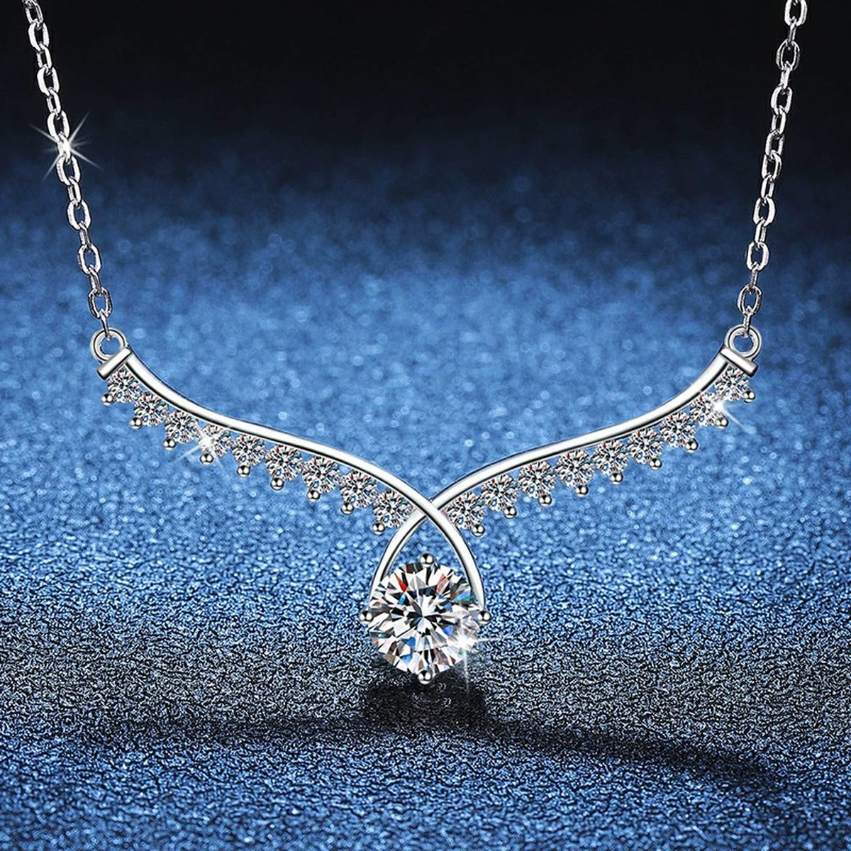 Pear Drop Moissanite Collar Necklace in Platinum-Plated S925 Sterling Silver blue background close-up view
