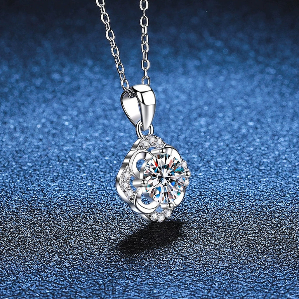Round Floral Halo Moissanite Pendant Necklace in Platinum-Plated S925 Sterling Silver blue background close-up view