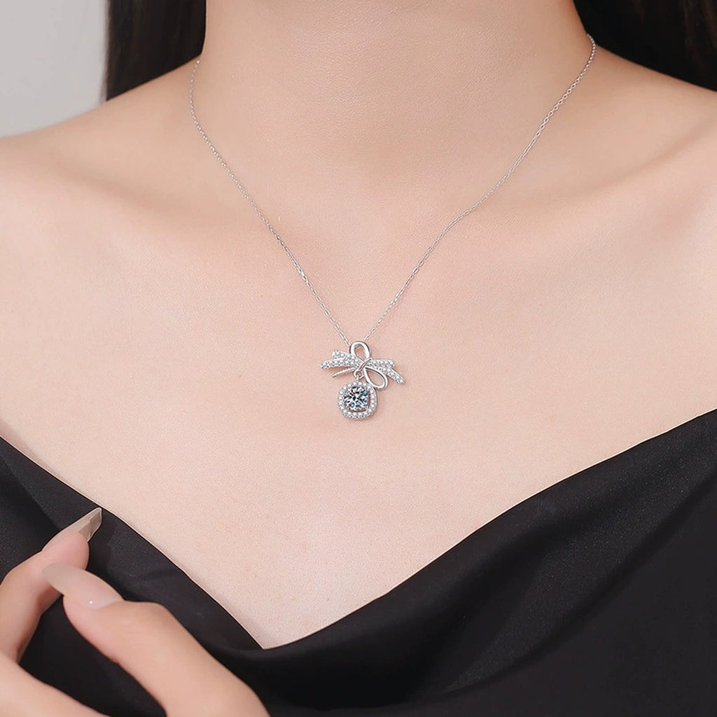 Bow Cushion Halo Moissanite Pendant Necklace in Platinum-Plated S925 Sterling Silver worn on neckline by model