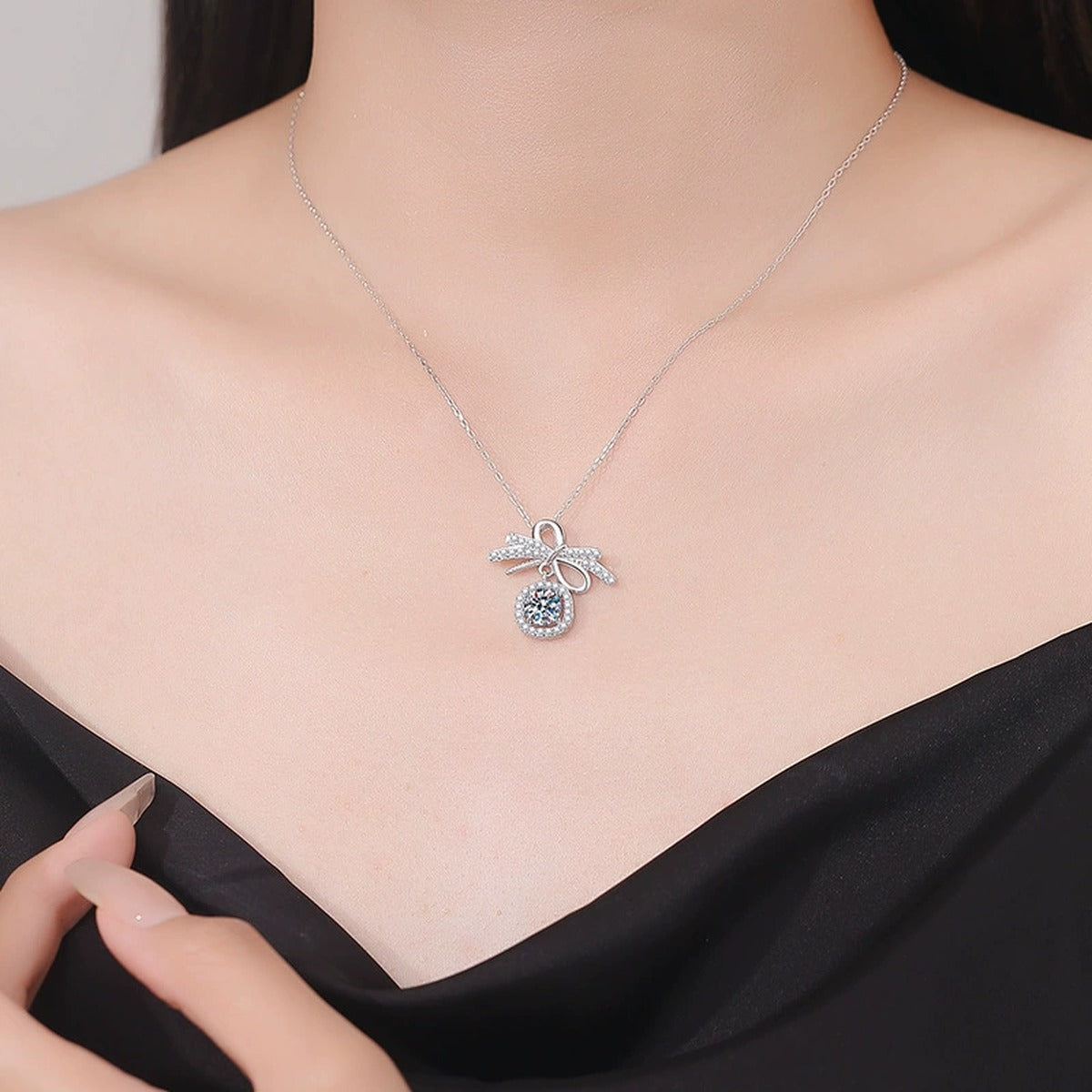 Bow Cushion Halo Moissanite Pendant Necklace in Platinum-Plated S925 Sterling Silver worn on neckline by model