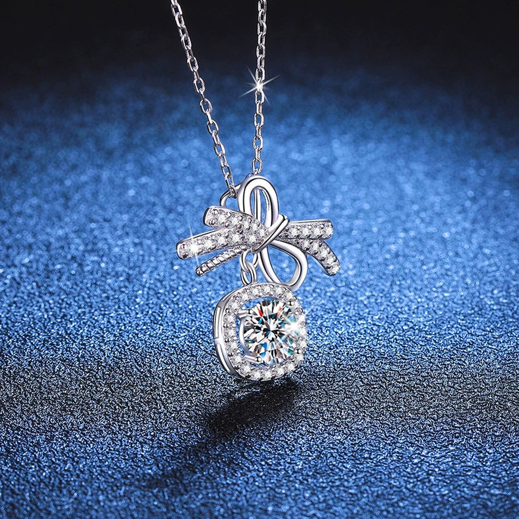 Bow Cushion Halo Moissanite Pendant Necklace in Platinum-Plated S925 Sterling Silver blue background close-up view