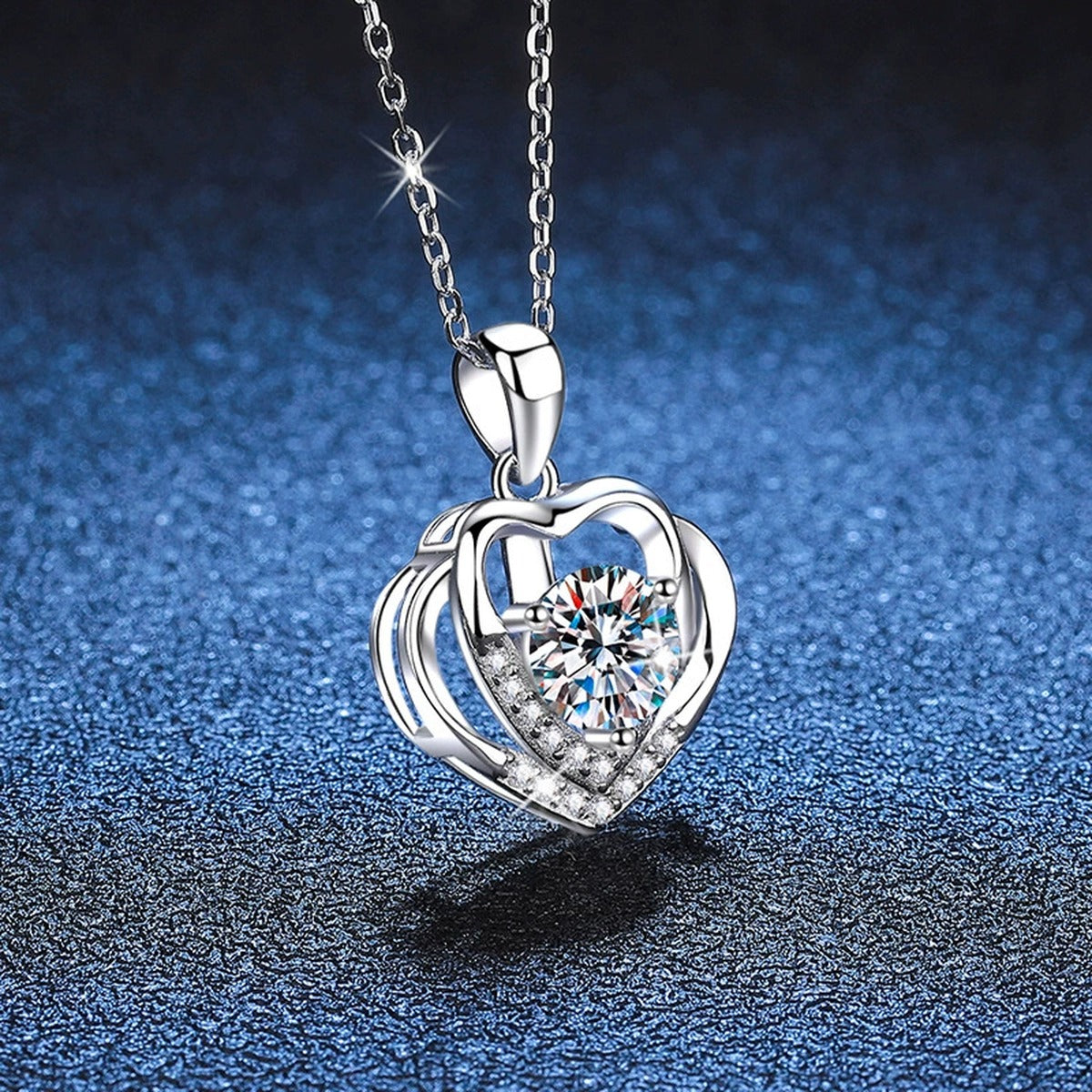 Heart Frame Moissanite Pendant Necklace in Platinum-Plated S925 Sterling Silver blue background angled view