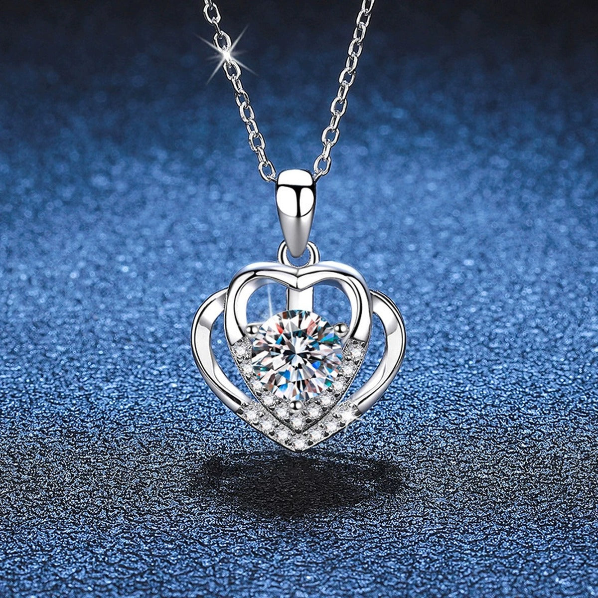 Heart Frame Moissanite Pendant Necklace in Platinum-Plated S925 Sterling Silver blue background close-up view