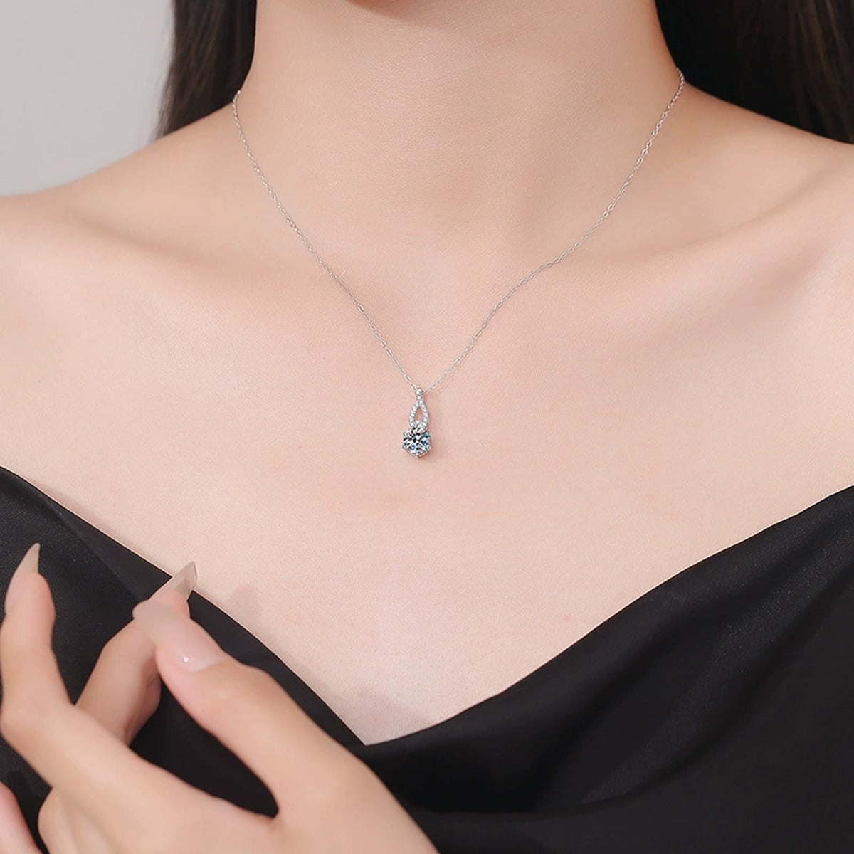 Teardrop Moissanite Pendant Necklace in Platinum-Plated S925 Sterling Silver worn on neckline by model