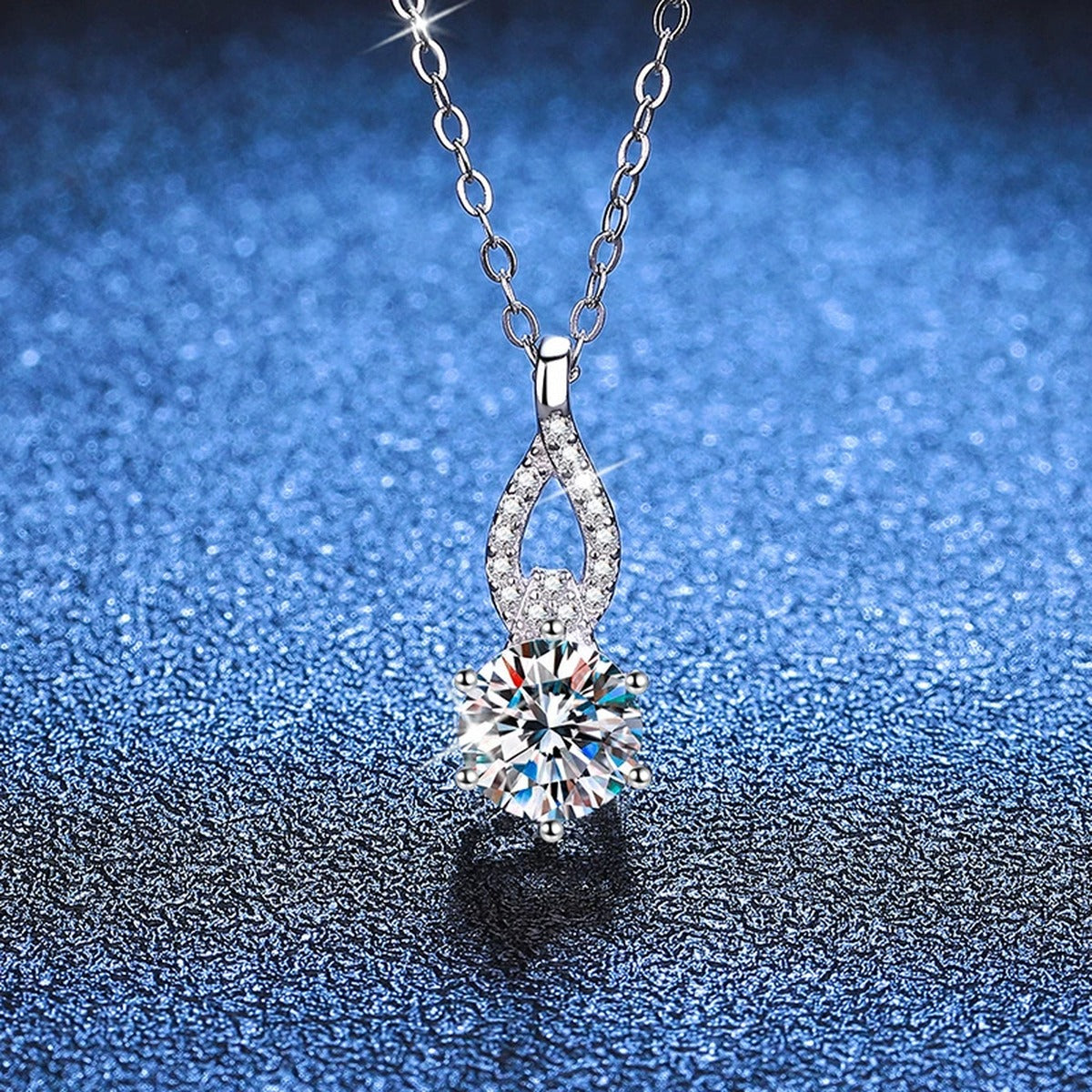 Teardrop Moissanite Pendant Necklace in Platinum-Plated S925 Sterling Silver blue background angled view