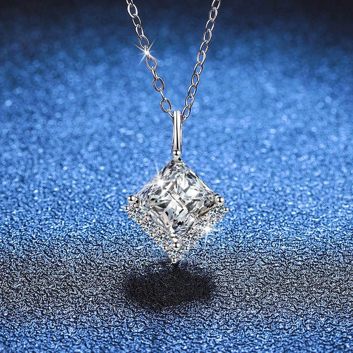 Princess-Cut Moissanite Pendant Necklace in Platinum-Plated S925 Sterling Silver blue background close-up view