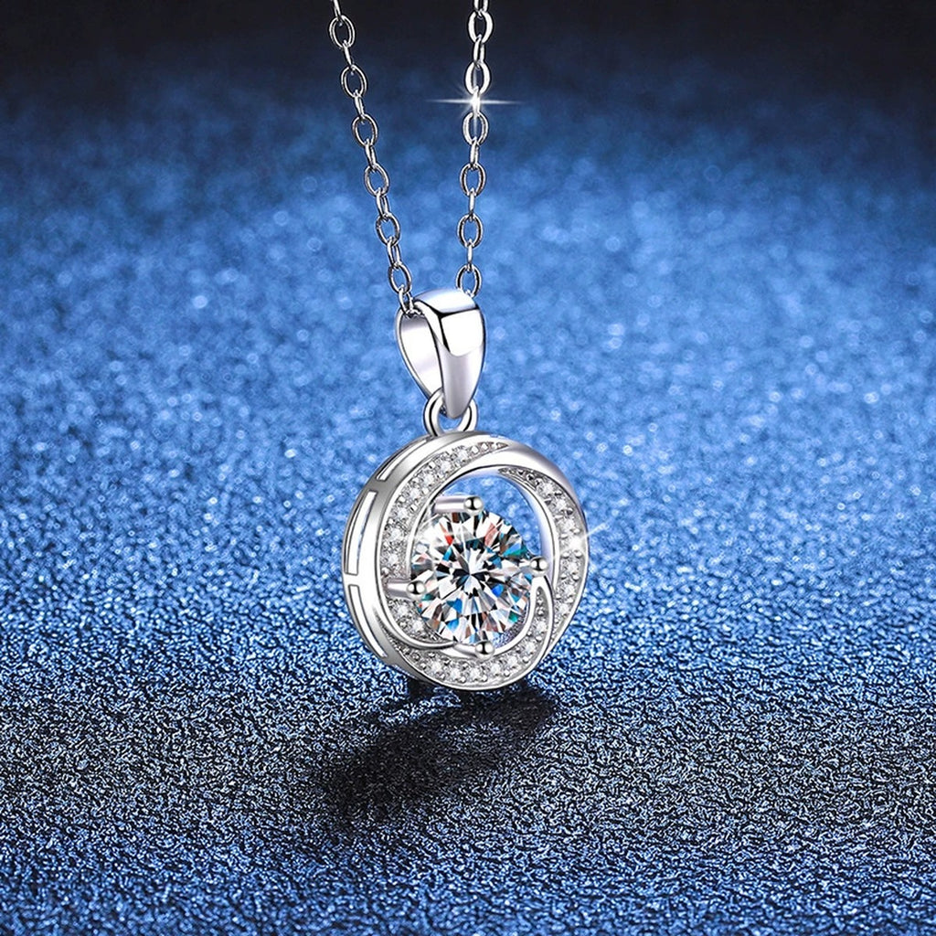 Round Bezel Halo Moissanite Pendant Necklace in Platinum-Plated S925 Sterling Silver blue background angled view