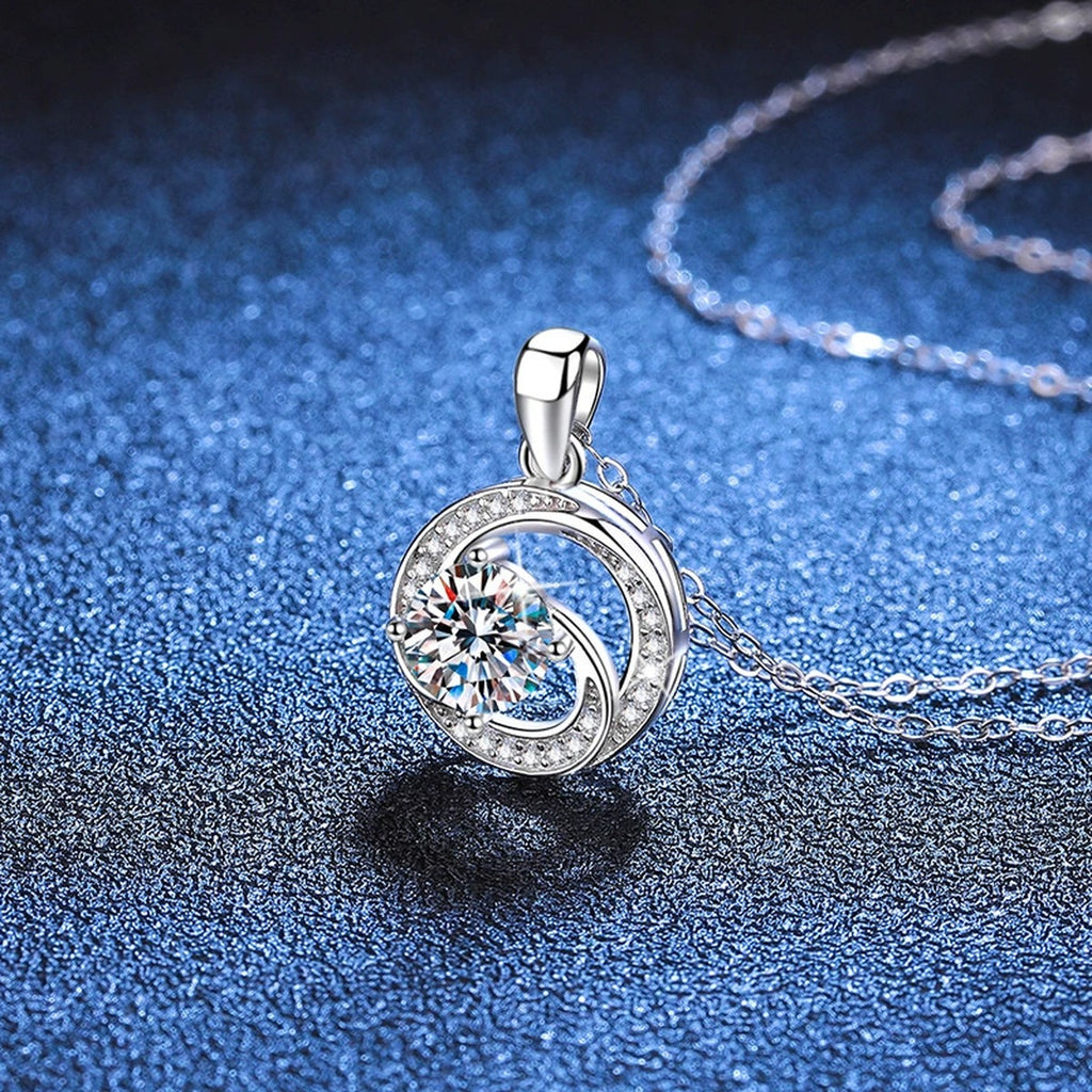 Round Bezel Halo Moissanite Pendant Necklace in Platinum-Plated S925 Sterling Silver blue background close-up view