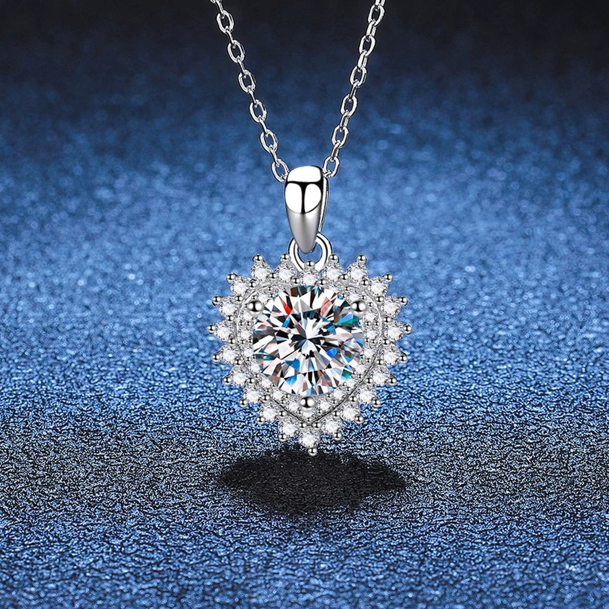 Round Halo Moissanite Pendant Necklace in Platinum-Plated S925 Sterling Silver blue background close-up view
