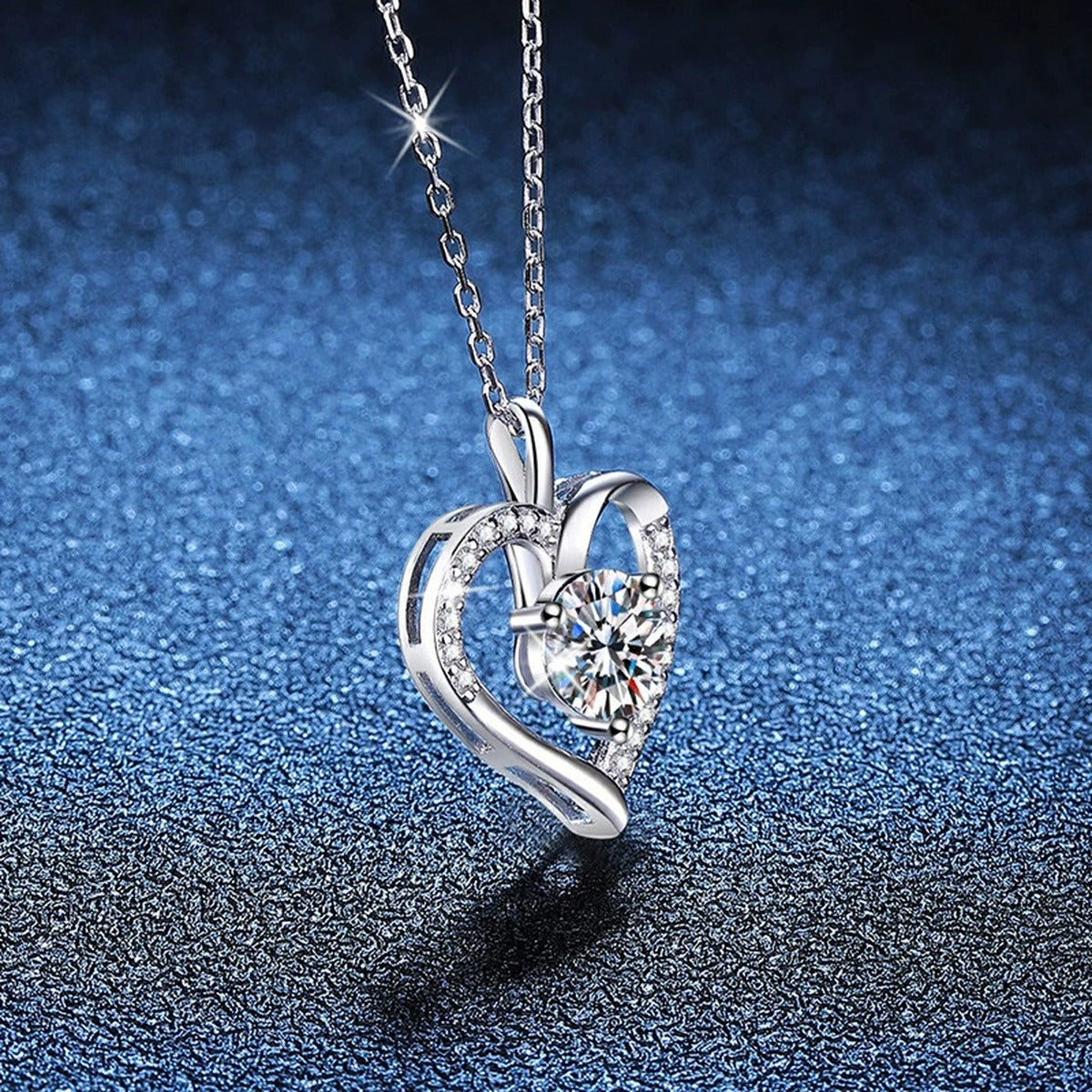 Open Heart Moissanite Pendant Necklace in Platinum-Plated S925 Sterling Silver blue background angled view