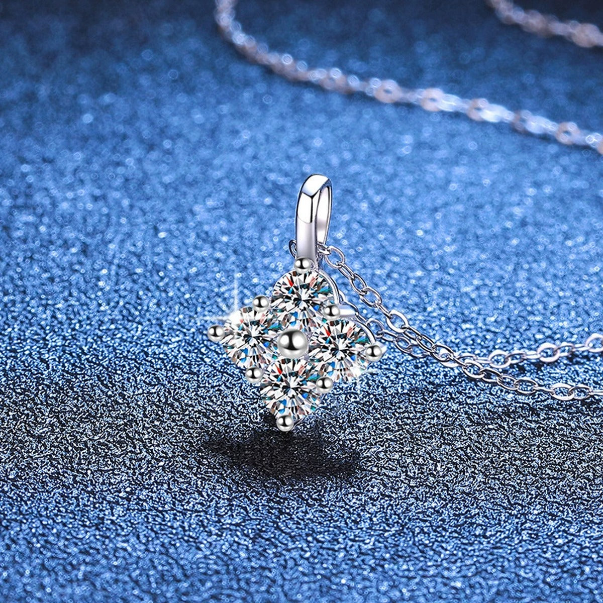 Four-Stone Cluster Moissanite Pendant Necklace in Platinum-Plated S925 Sterling Silver blue background angled view