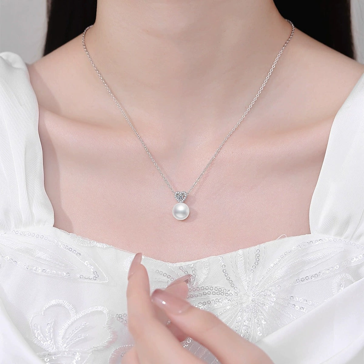 Moissanite Freshwater Pearl Pendant Necklace with Cubic Zirconia in White Gold-Plated S925 Sterling Silver worn on neckline by model