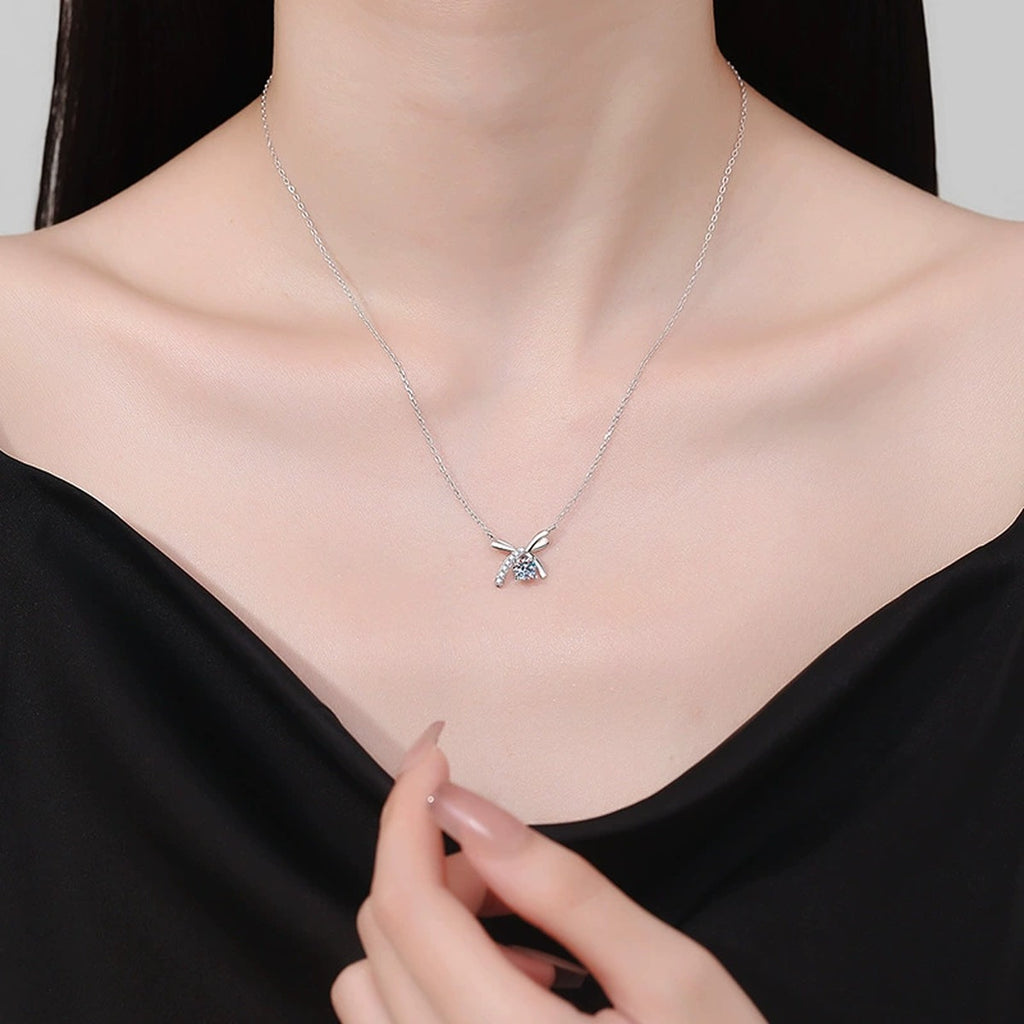 Bow Moissanite Pendant Necklace in Platinum-Plated S925 Sterling Silver worn on neckline by model