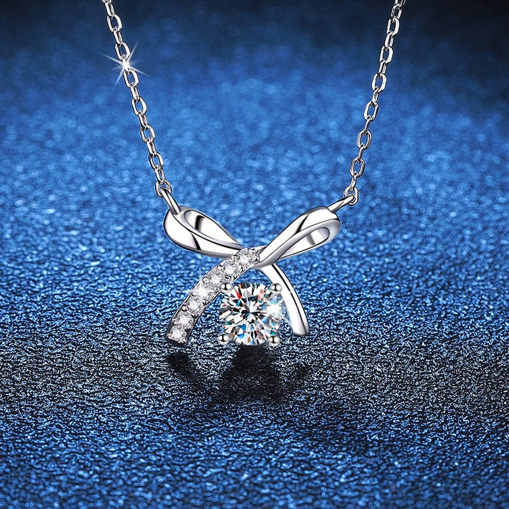 Bow Moissanite Pendant Necklace in Platinum-Plated S925 Sterling Silver blue background angled view