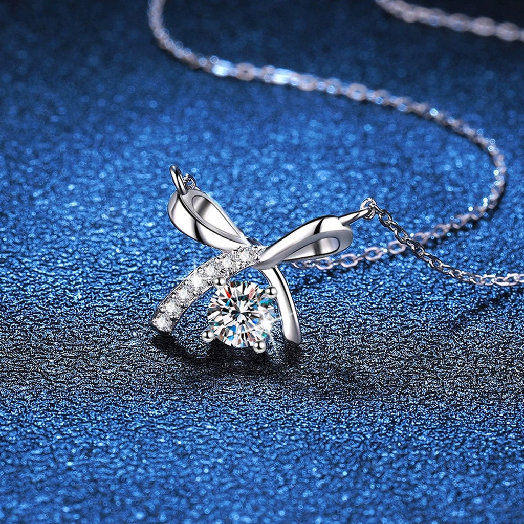 Bow Moissanite Pendant Necklace in Platinum-Plated S925 Sterling Silver blue background close-up view