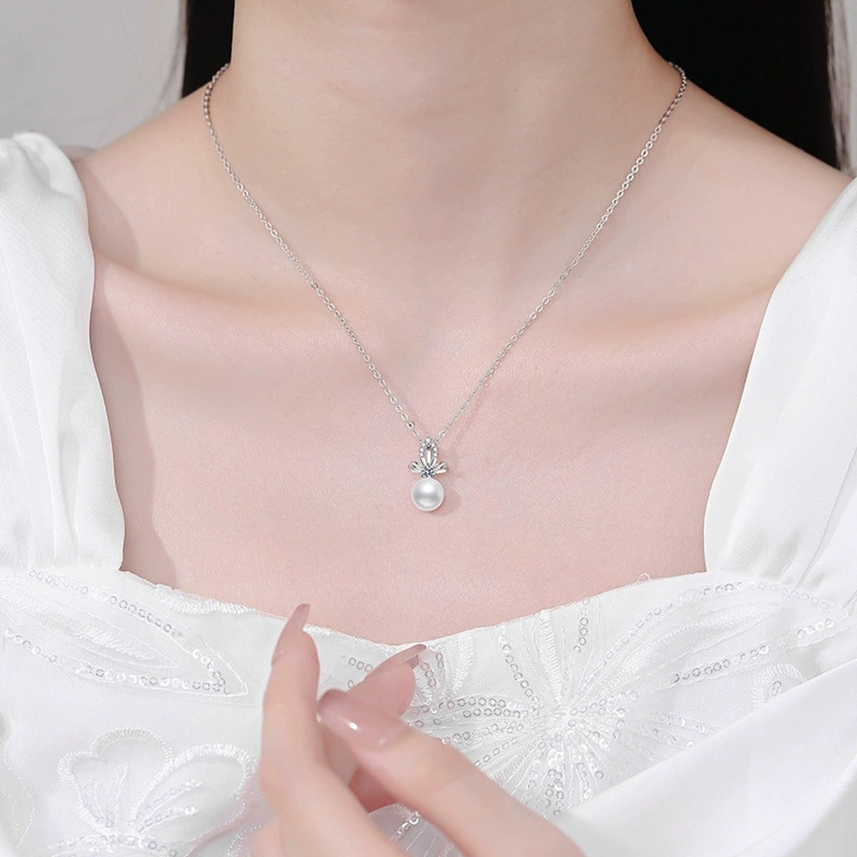 Moissanite Freshwater Pearl Pendant Necklace with Cubic Zirconia in White Gold-Plated S925 Sterling Silver worn on neckline by model