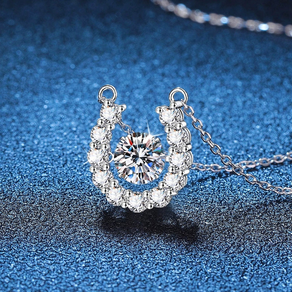 Horseshoe Halo Moissanite Pendant Necklace in Platinum-Plated S925 Sterling Silver blue background angled view